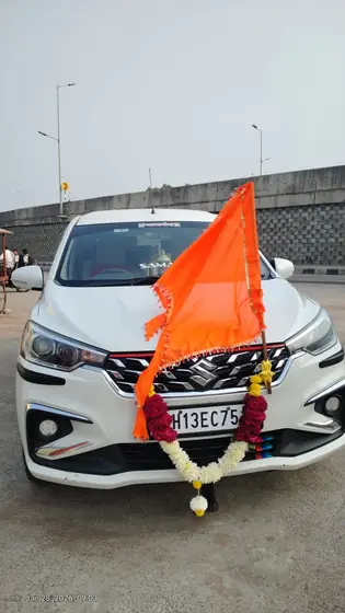 Ertiga pilgrimage taxi with saffron flag in Solapur